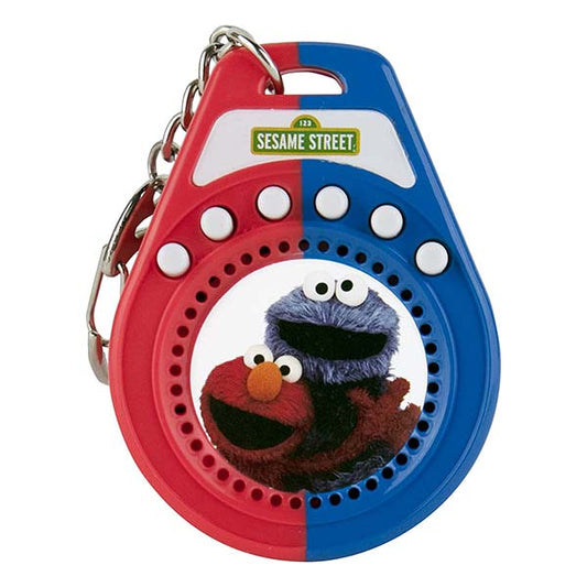 World’s Coolest Sesame Street Talking Keychain includes 6 phrases featuring Elmo and Cookie Monster. Elmo Phrases: “Let’s, Rock Baby!”, “Giggle”, “Way Cool!” Cookie Monster Phrases: “Num Num Delicious”, “Oh, What Gorgeous Looking Cookie,” and “Now Me Eat Cookie!”